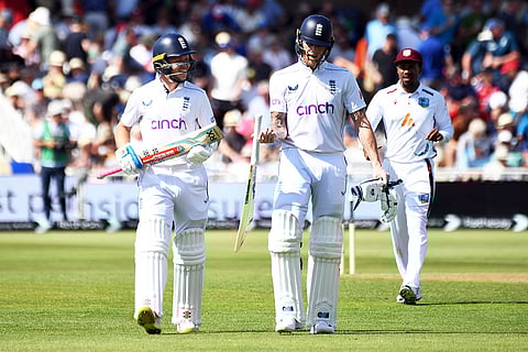 Ollie Pope walks off with Ben Stokes for tea break